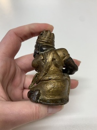A small Chinese gilt bronze paperweight in the form of a kneeling foreigner, Ming