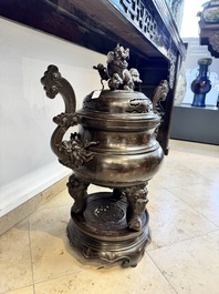 A massive Vietnamese copper- and silver-inlaid 'Buddhist lion' censer and cover on stand, 19th C.