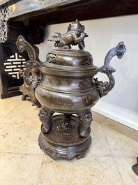 A massive Vietnamese copper- and silver-inlaid 'Buddhist lion' censer and cover on stand, 19th C.