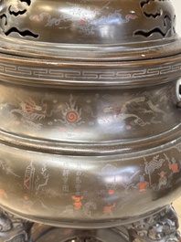 A massive Vietnamese copper- and silver-inlaid 'Buddhist lion' censer and cover on stand, 19th C.