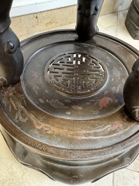 A massive Vietnamese copper- and silver-inlaid 'Buddhist lion' censer and cover on stand, 19th C.