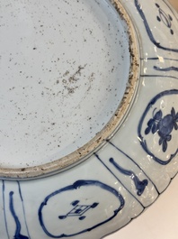 A Chinese blue and white 'kraak' dish with Damo in a landscape, Wanli
