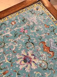 A Chinese famille rose turquoise-ground 'flower scrolls and bats' plaque, later mounted as table, Qianlong