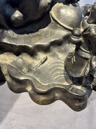 A rare Chinese bronze group depicting two immortals and various animals in a mountainous landscape, Ming