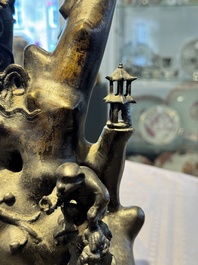 A rare Chinese bronze group depicting two immortals and various animals in a mountainous landscape, Ming