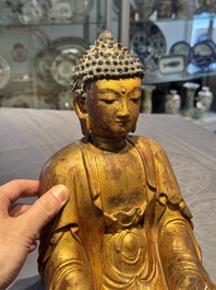 A Chinese gilt-lacquered wooden sculpture of Buddha, Ming