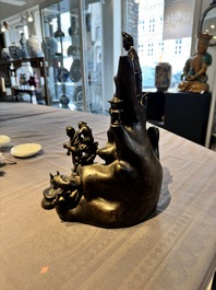 A rare Chinese bronze group depicting two immortals and various animals in a mountainous landscape, Ming