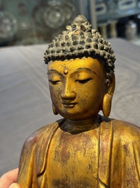 A Chinese gilt-lacquered wooden sculpture of Buddha, Ming