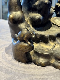 A rare Chinese bronze group depicting two immortals and various animals in a mountainous landscape, Ming