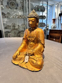 A Chinese gilt-lacquered wooden sculpture of Buddha, Ming