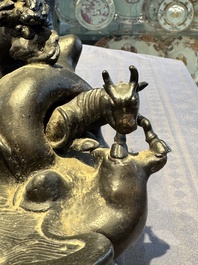 A rare Chinese bronze group depicting two immortals and various animals in a mountainous landscape, Ming