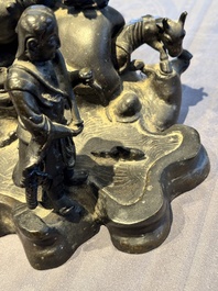 A rare Chinese bronze group depicting two immortals and various animals in a mountainous landscape, Ming
