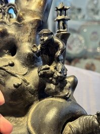 A rare Chinese bronze group depicting two immortals and various animals in a mountainous landscape, Ming