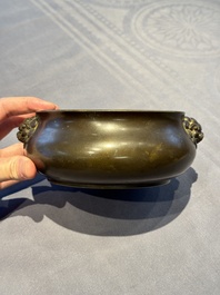 A Chinese bronze censer with lion-form handles, 大明宣德五年監造工部官監吳邦佐造 mark, 18th C.