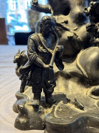 A rare Chinese bronze group depicting two immortals and various animals in a mountainous landscape, Ming