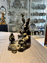 A rare Chinese bronze group depicting two immortals and various animals in a mountainous landscape, Ming
