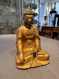 A Chinese gilt-lacquered wooden sculpture of Buddha, Ming