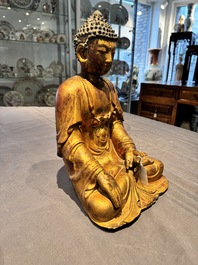 A Chinese gilt-lacquered wooden sculpture of Buddha, Ming