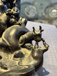 A rare Chinese bronze group depicting two immortals and various animals in a mountainous landscape, Ming