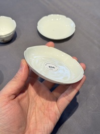 A pair of Chinese eggshell white-glazed cups and saucers, and two famille rose cups, 18th C.