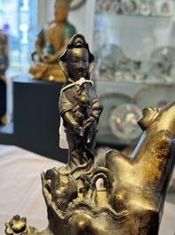 A rare Chinese bronze group depicting two immortals and various animals in a mountainous landscape, Ming