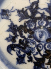 A Chinese blue and white celadon-ground plate with floral design, Ming