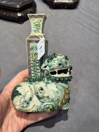 A pair of Chinese verte biscuit vases resting on Buddhist lions, Kangxi