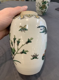 A pair of Chinese famille verte 'pheasant among flowering branches' vases and covers, 19th C.