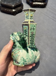 A pair of Chinese verte biscuit vases resting on Buddhist lions, Kangxi