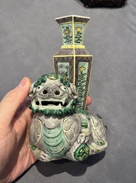 A pair of Chinese verte biscuit vases resting on Buddhist lions, Kangxi