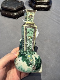 A pair of Chinese verte biscuit vases resting on Buddhist lions, Kangxi