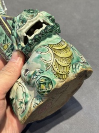 A pair of Chinese verte biscuit vases resting on Buddhist lions, Kangxi