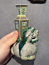 A pair of Chinese verte biscuit vases resting on Buddhist lions, Kangxi