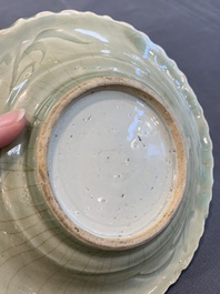A Chinese blue and white celadon-ground plate with floral design, Ming