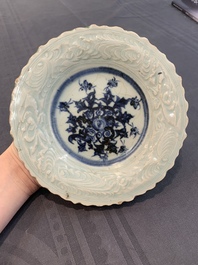 A Chinese blue and white celadon-ground plate with floral design, Ming