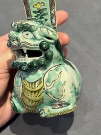 A pair of Chinese verte biscuit vases resting on Buddhist lions, Kangxi