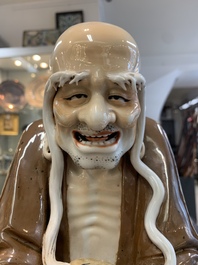 A Chinese brown- and caf&eacute;-au-lait-glazed Luohan, Zeng Longsheng 曾龍升 mark, 20th C.