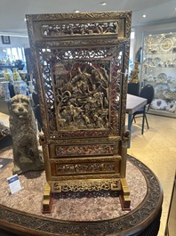 A pair of Chinese gilt-lacquered openworked wooden table screens with warriors on horseback, 19th C.