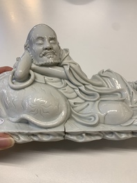 A Chinese Dehua blanc de Chine figure of a Luohan reclining on a tiger, Dehua and Bo Ji Yu Ren 博及漁人 mark, 20th C.