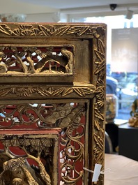 A pair of Chinese gilt-lacquered openworked wooden table screens with warriors on horseback, 19th C.
