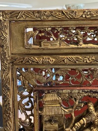 A pair of Chinese gilt-lacquered openworked wooden table screens with warriors on horseback, 19th C.
