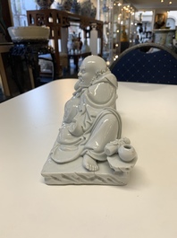 A Chinese Dehua blanc de Chine figure of a Luohan reclining on a tiger, Dehua and Bo Ji Yu Ren 博及漁人 mark, 20th C.