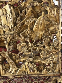 A pair of Chinese gilt-lacquered openworked wooden table screens with warriors on horseback, 19th C.