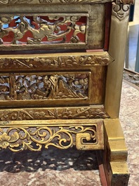 A pair of Chinese gilt-lacquered openworked wooden table screens with warriors on horseback, 19th C.