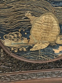 A Chinese wooden table screen with an embroidered silk with turtle design, 19th C.