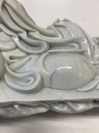 A Chinese Dehua blanc de Chine figure of a Luohan reclining on a tiger, Dehua and Bo Ji Yu Ren 博及漁人 mark, 20th C.