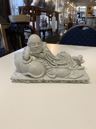A Chinese Dehua blanc de Chine figure of a Luohan reclining on a tiger, Dehua and Bo Ji Yu Ren 博及漁人 mark, 20th C.
