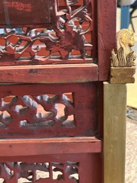 A pair of Chinese gilt-lacquered openworked wooden table screens with warriors on horseback, 19th C.