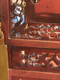 A pair of Chinese gilt-lacquered openworked wooden table screens with warriors on horseback, 19th C.
