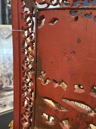 A pair of Chinese gilt-lacquered openworked wooden table screens with warriors on horseback, 19th C.
